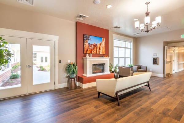 Bright common area with seating and fireplace