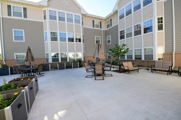 Outdoor patio area with seating and gardens