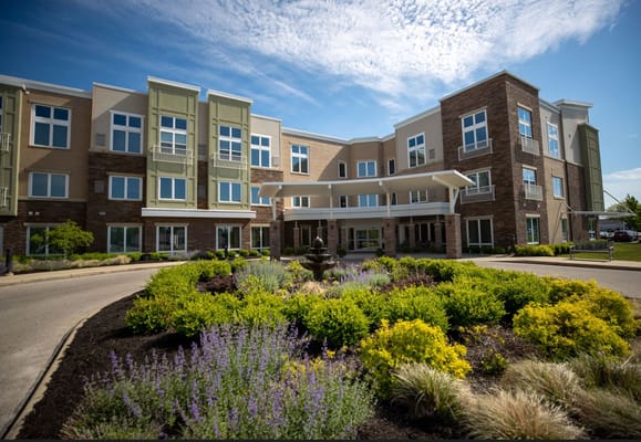 Exterior view of a senior living facility with landscaped gardens