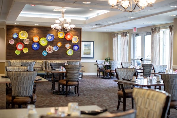 Dining room with colorful wall art and table settings