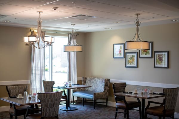 Bright dining room with tables and artwork