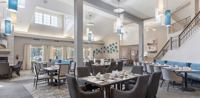 Bright, spacious dining room with tables set for meals