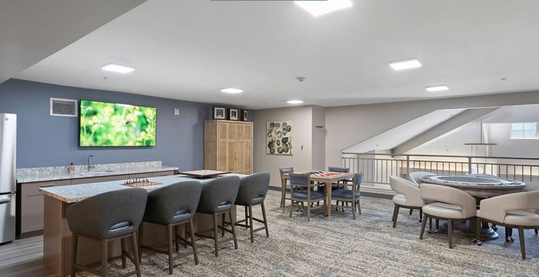 Bright interior common area with seating and gaming options