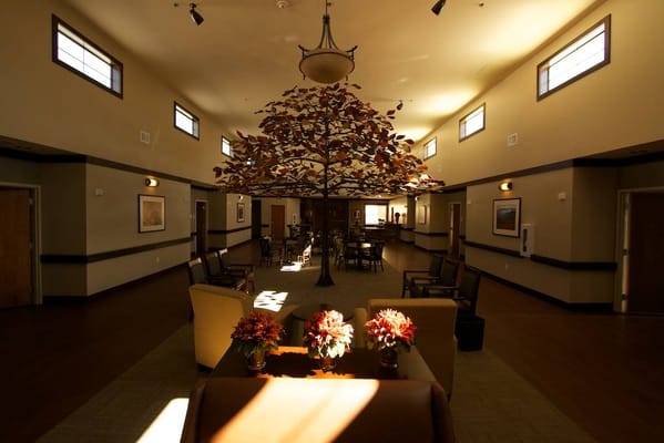 Interior view of a common area with a tree sculpture
