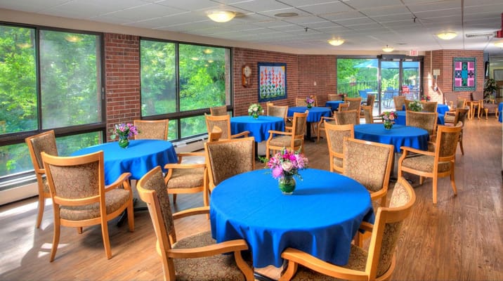 Bright dining area with blue tablecloths and flowers