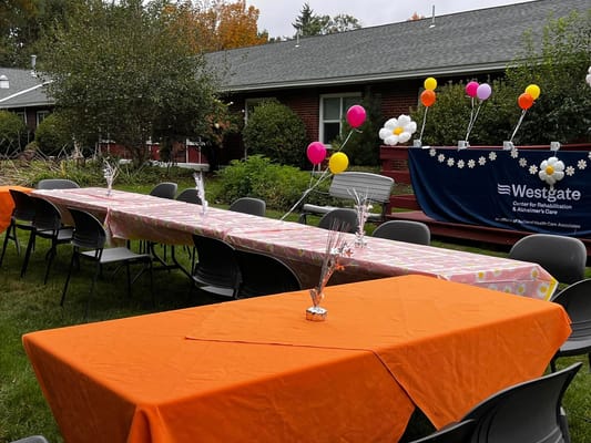Outdoor celebration setup with decorated tables at Westgate Manor
