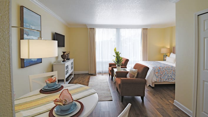 Bright interior view of a resident suite with dining area