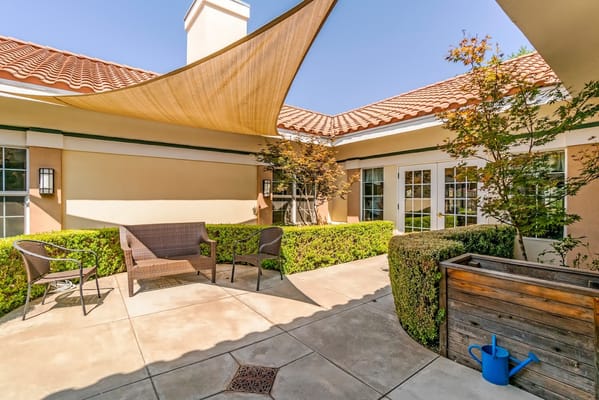 Outdoor patio area with seating and sun shade