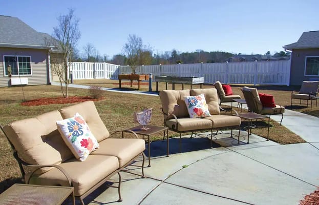 Outdoor patio with comfortable seating and decorative pillows.