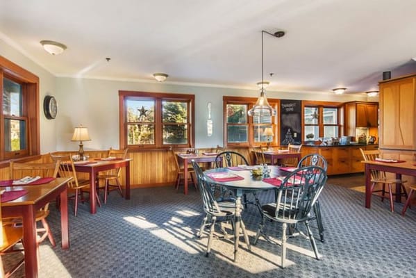 Bright dining area with wooden tables and chairs