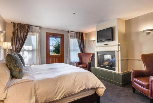 Modern resident room with a fireplace and seating area