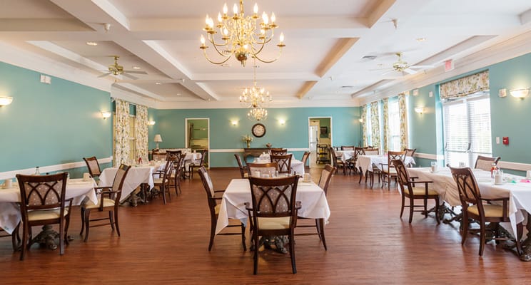 Dining area with tables and chairs in a bright room