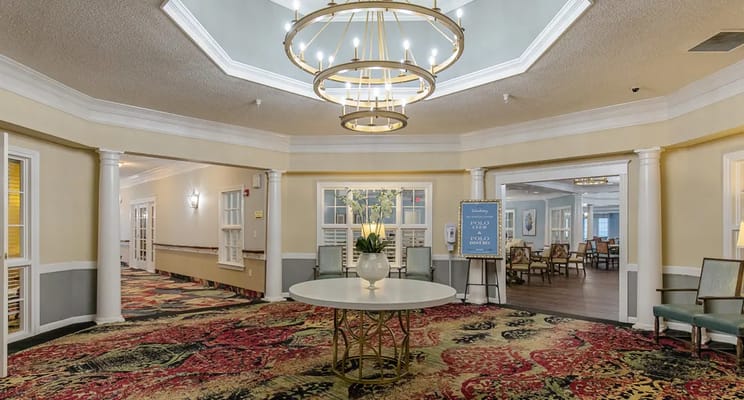Bright lobby area with chandelier and floral decor