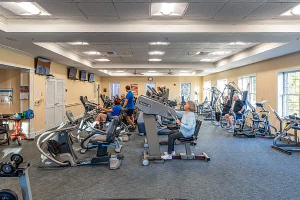 Residents using gym equipment in fitness center