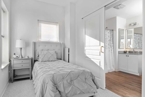 Bright interior of a private resident room with bathroom