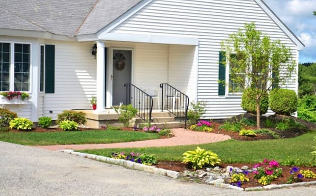 Exterior view of a welcoming entrance with flowerbeds