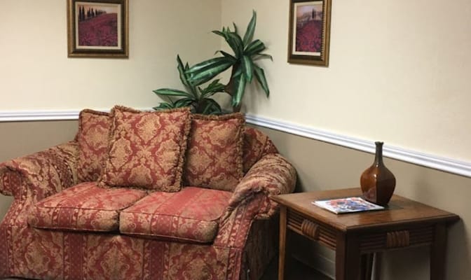 Comfortable seating area with a couch and side table.