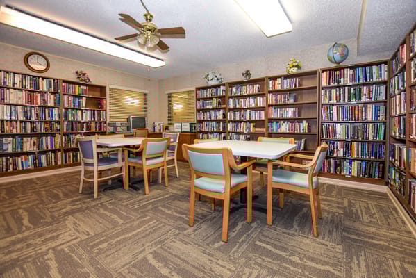 Interior view of a library with bookshelves and tables