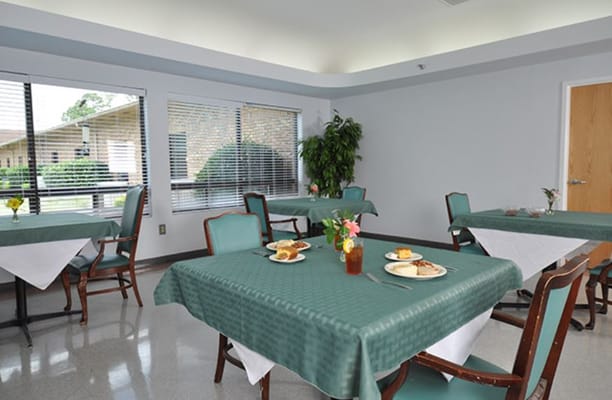 Dining room setting with tables and meals prepared