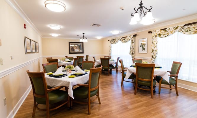 Bright dining room with neatly set tables and chairs