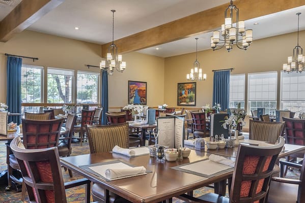 Bright dining area with tables and chairs set for meals