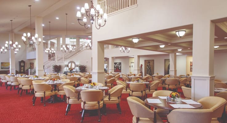 Spacious dining room with tables set for a meal