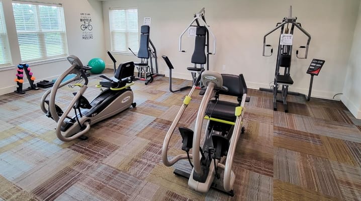 Fitness equipment in a well-lit exercise room