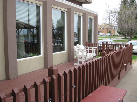 Outdoor deck area with seating in front of a building
