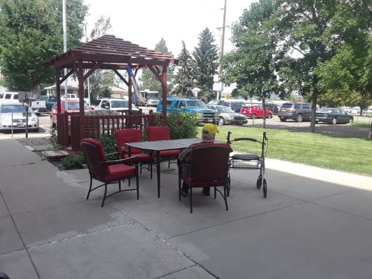 Outdoor seating area with resident enjoying the garden view