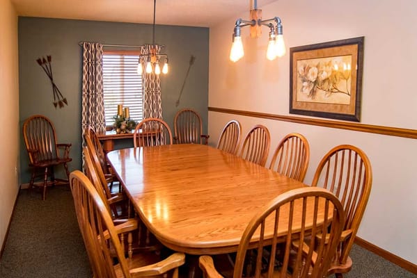 Dining room with large wooden table and chairs