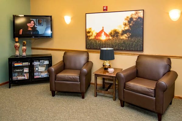 Cozy seating area in a common room with a TV