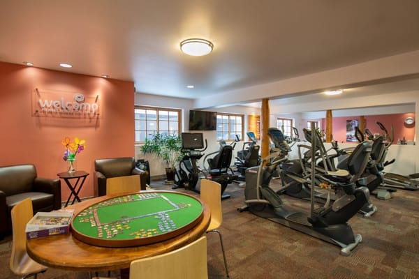 Interior of the fitness center with exercise equipment and seating area