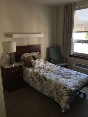 Cozy resident room with bed and chair