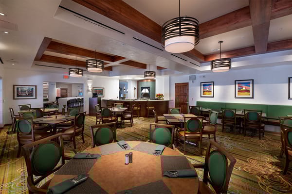 Dining room with circular tables and green chairs