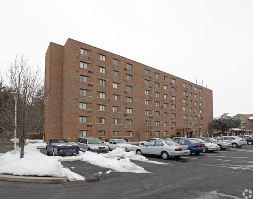 Exterior view of Luther Towers Of Dover with parking area
