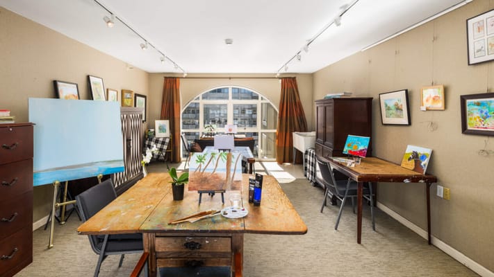 Art studio with wooden tables and artwork on display