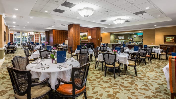 A spacious dining room with tables set for meals at The Carlisle.