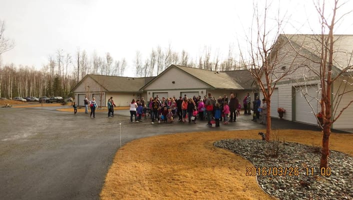 Group of people gathering outside Meadow Lakes Senior Housing