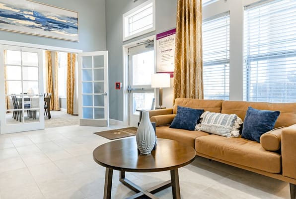 Cozy lobby with a sofa, coffee table, and large windows