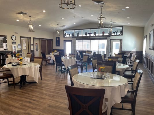 Bright dining area with tables and chairs set up