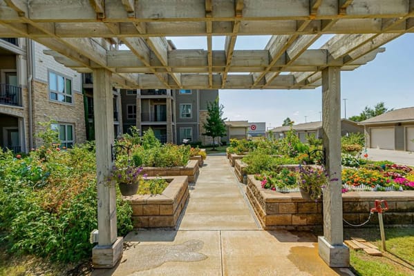 Flower garden pathway leading to an apartment building