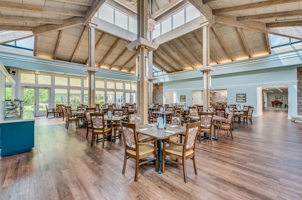 Bright and spacious dining area with wooden tables and chairs