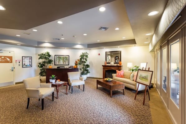 Welcoming lobby with seating and plants at Summerfield of Fresno
