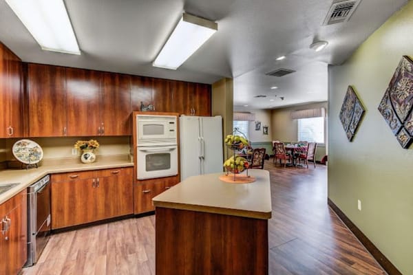 Modern kitchen in a senior living facility with wooden cabinetry