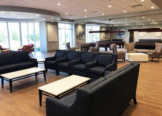 Spacious lounge with seating and natural light