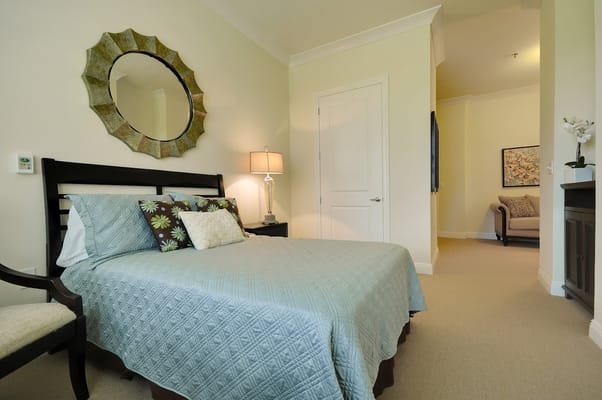 Brightly decorated private resident room with a bed