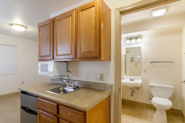 Interior view of a kitchen and bathroom area in a resident room
