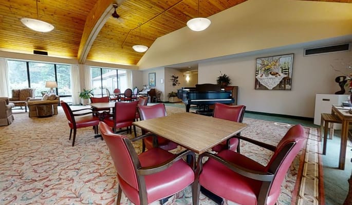 Bright living area with seating and a piano