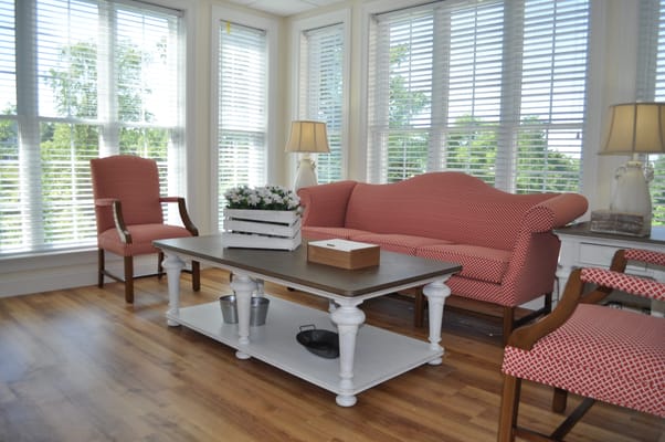 Cozy living room with red patterned furniture and natural light