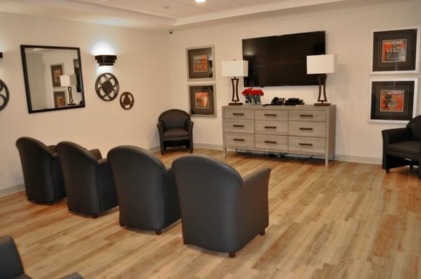 Lounge area with comfortable seating and a television.